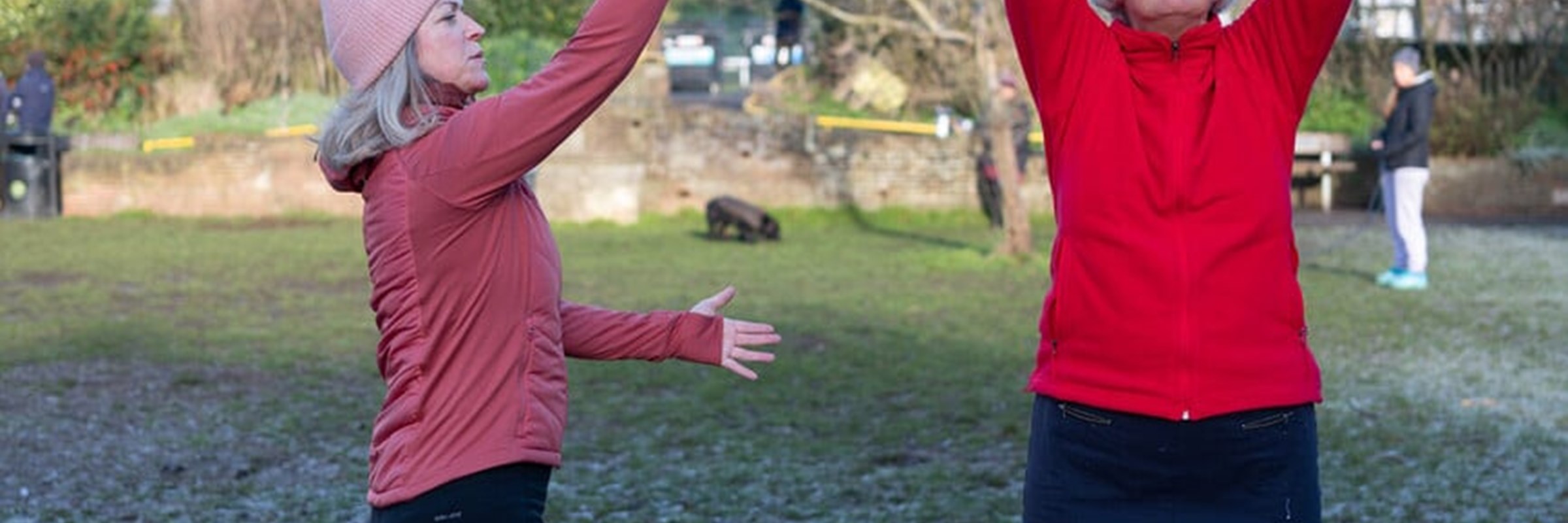 Two women stretching outside