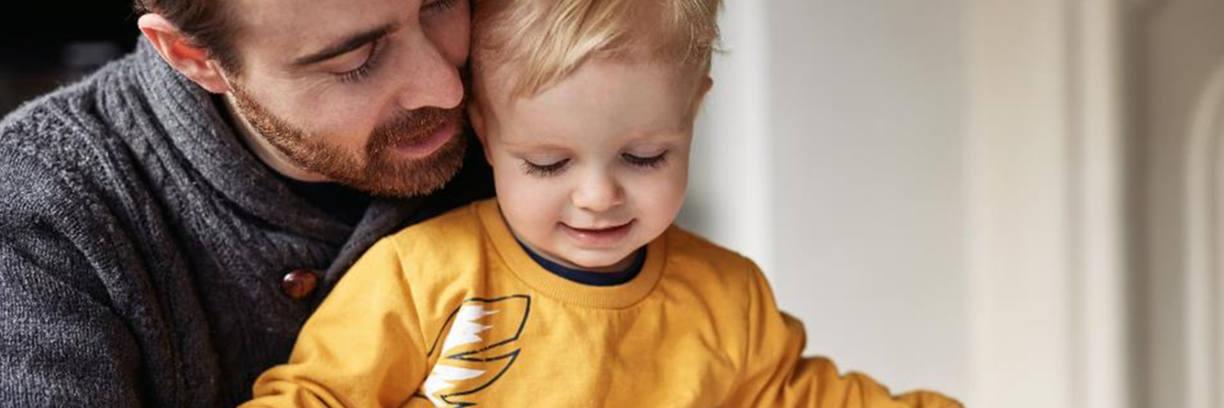 man and child reading book