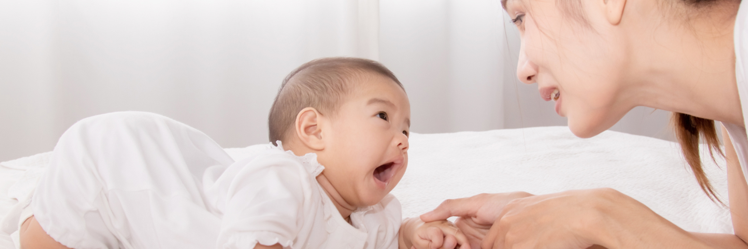 woman playing with baby