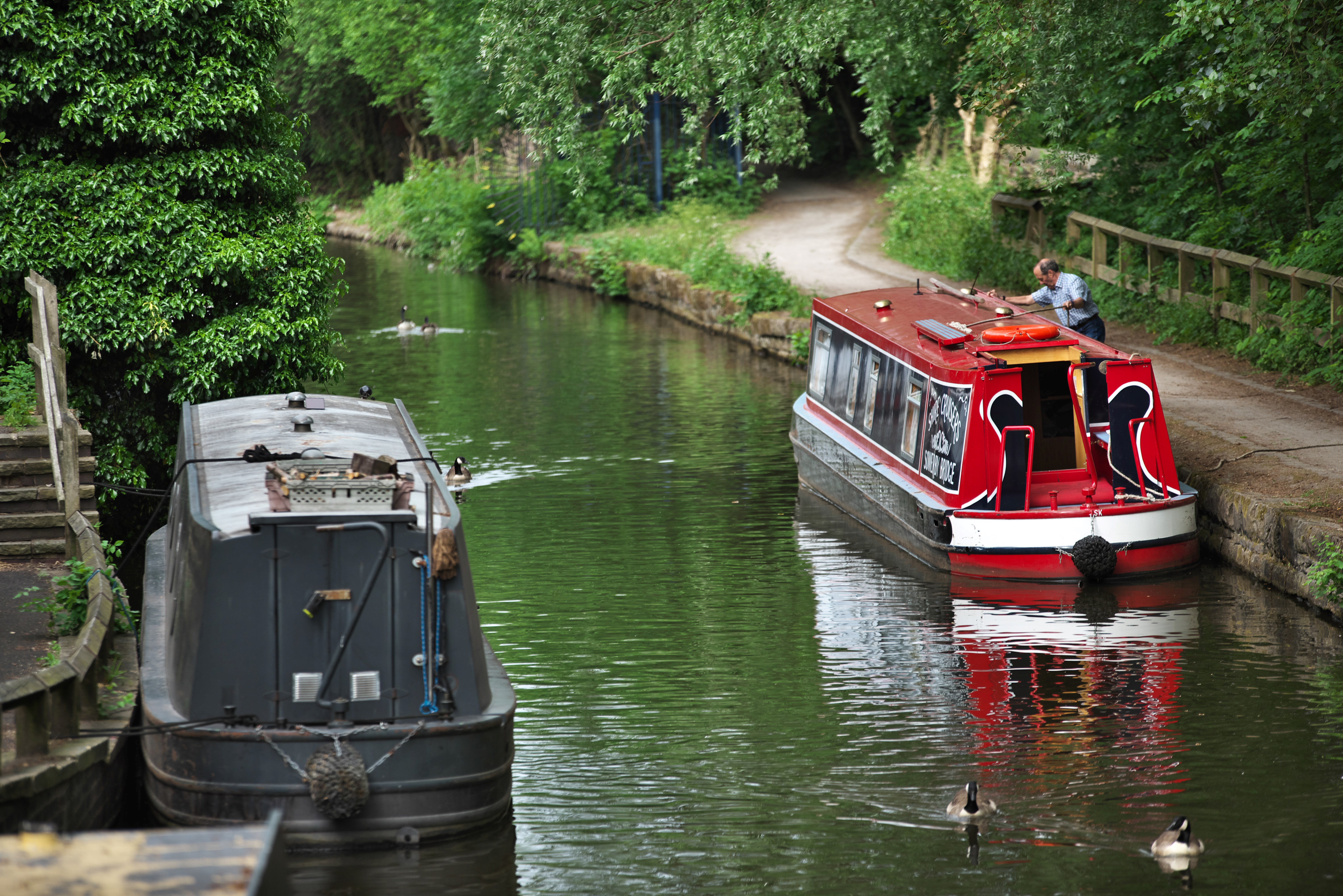 Two canal barges parked on a canal.