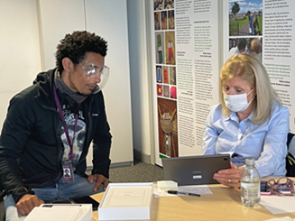 An image of a man and a women working on a tablet together