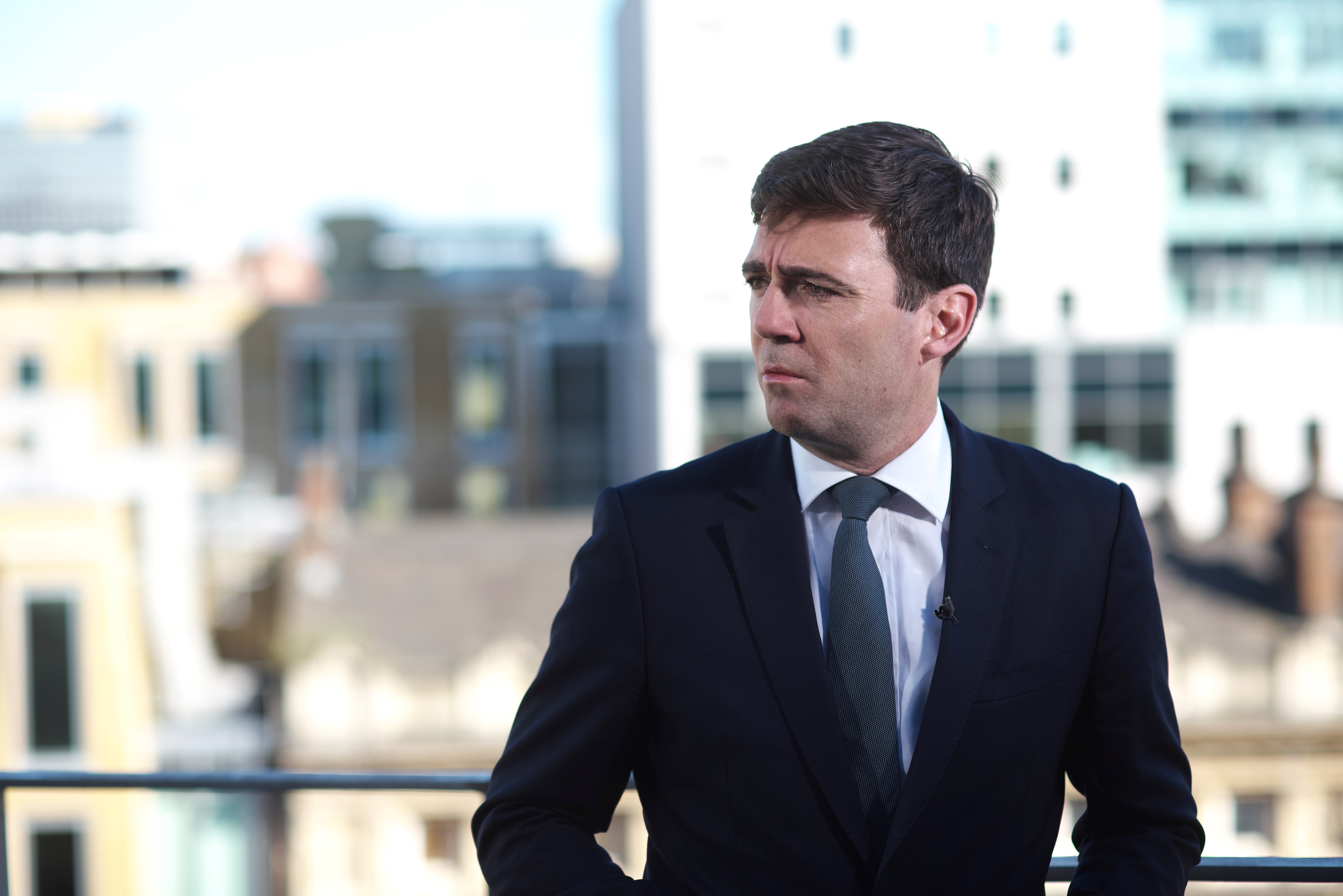 Mayor of Greater Manchester, Andy Burnham, in front of Manchester skyline