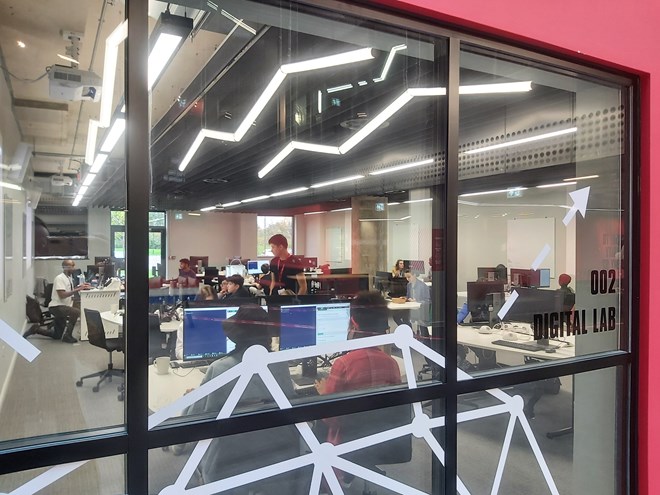 An image of a room of people learning on computers