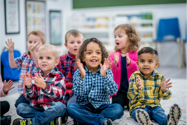 Six happy children clapping