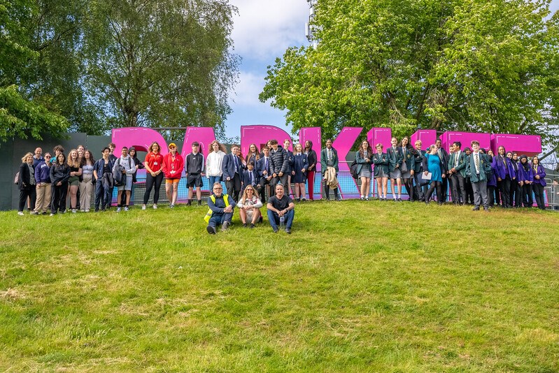 School pupils, teachers, Sacha Lord and Parklife team in front of Parklife sign at the festival