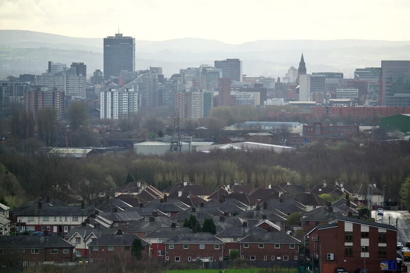 A picture of houses in Greater Manchester with the city centre in the background