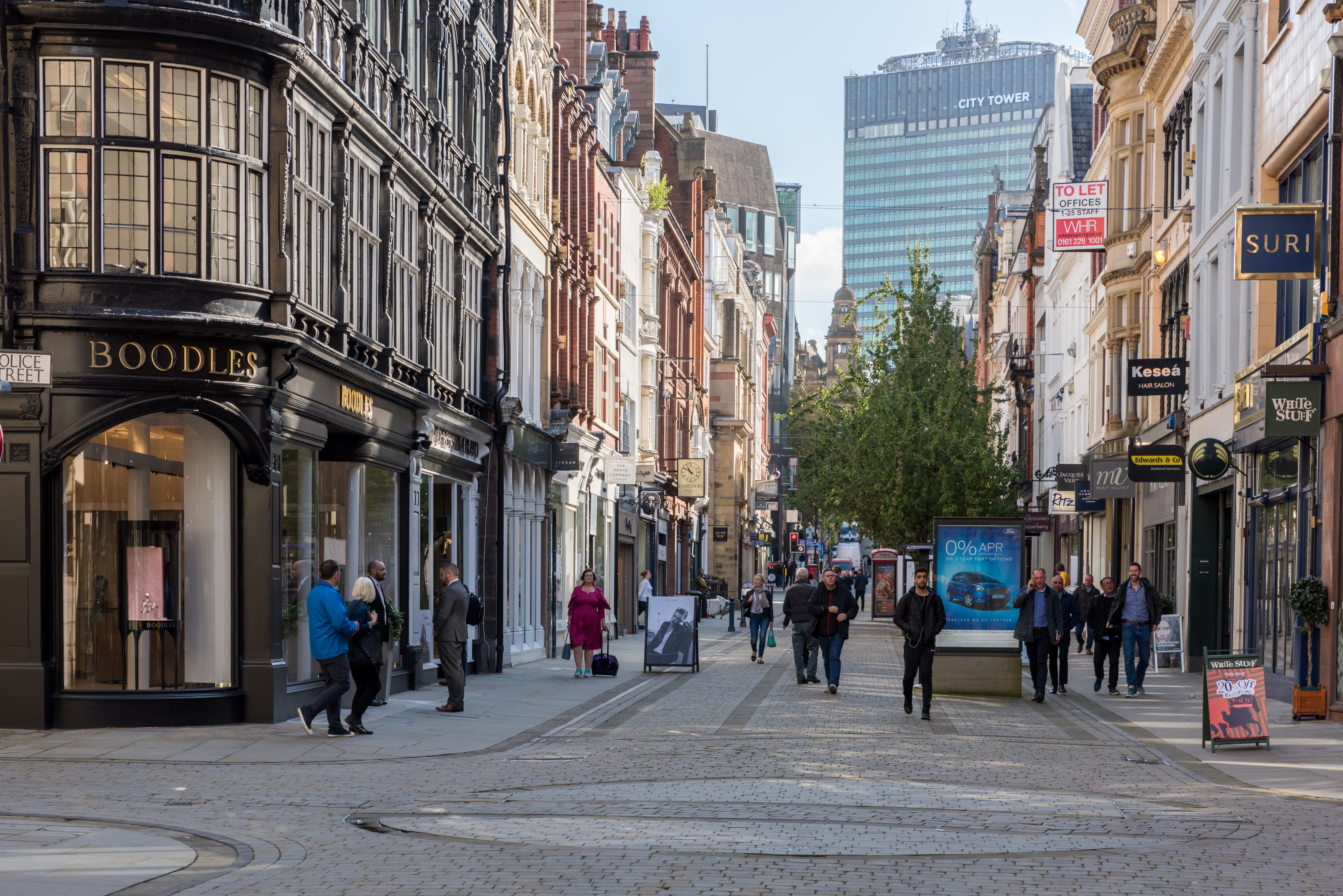 People walking down a street in Manchester City Centre