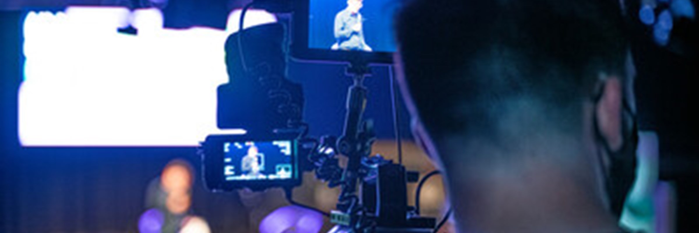 Back of a persons head by a camera