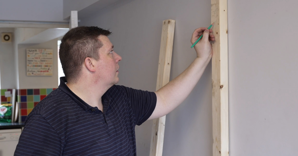 GM foster carer doing building and decorating work in a room