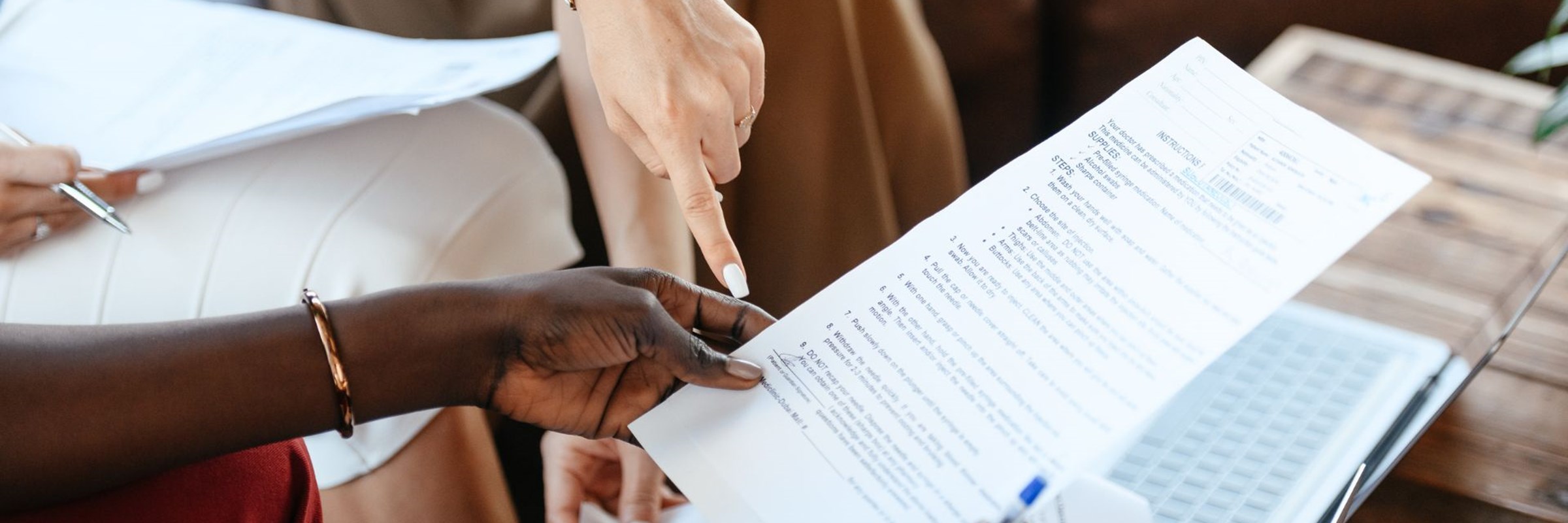 a group of people sitting around a table with papers in their hands