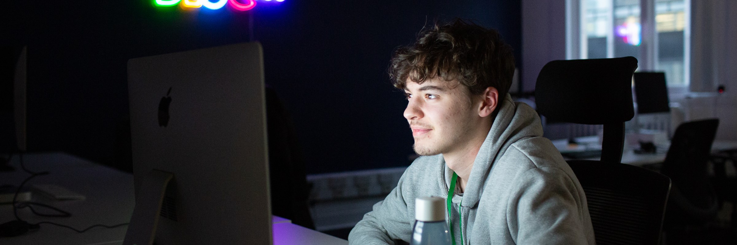 Person at desk working on a large screen