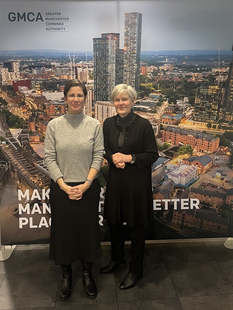 Deputy Mayor for Greater Manchester, Kate Green stood beside UN Special Rapporteur on violence against women and girls, its causes and consequences, Reem Alsalem, in front of a GMCA-branded banner.