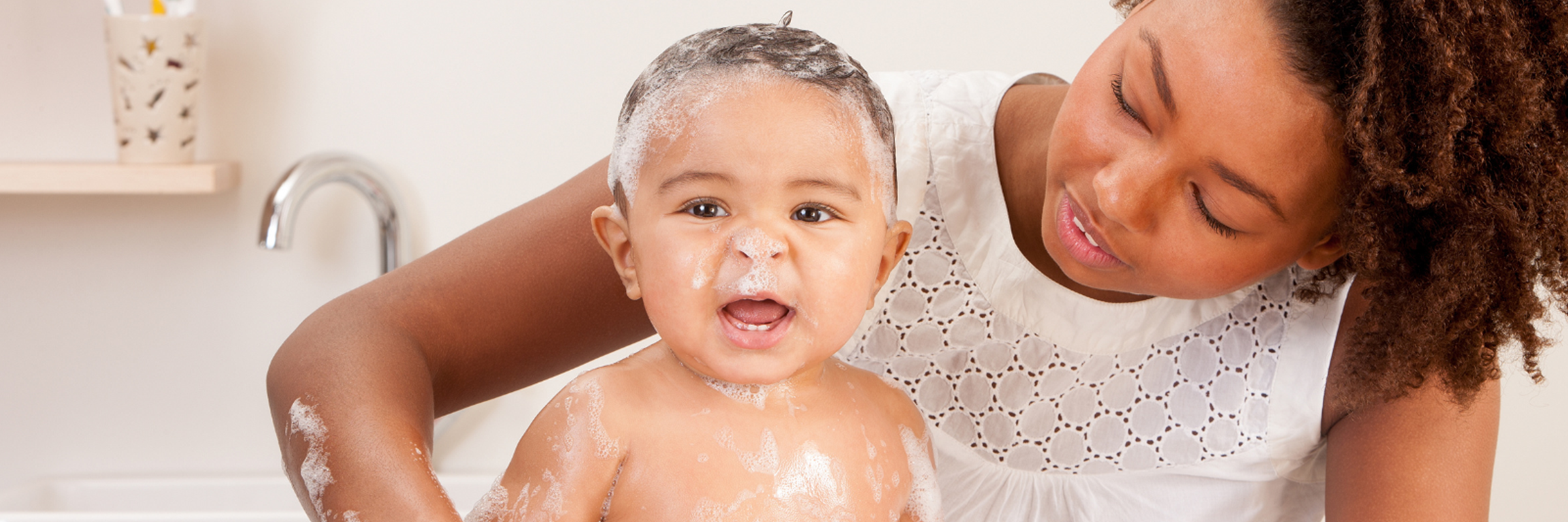 woman giving baby a bath