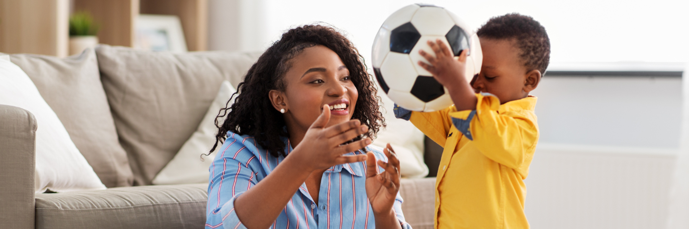 woman and child playing with football