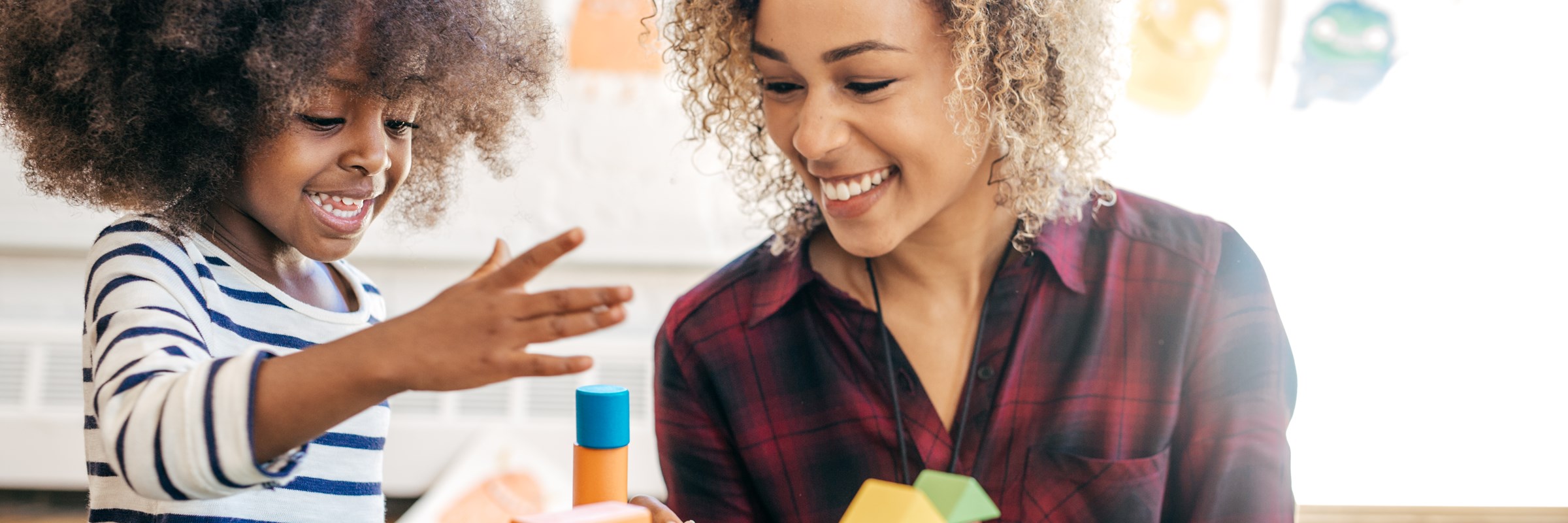 woman and child playing with building blocks