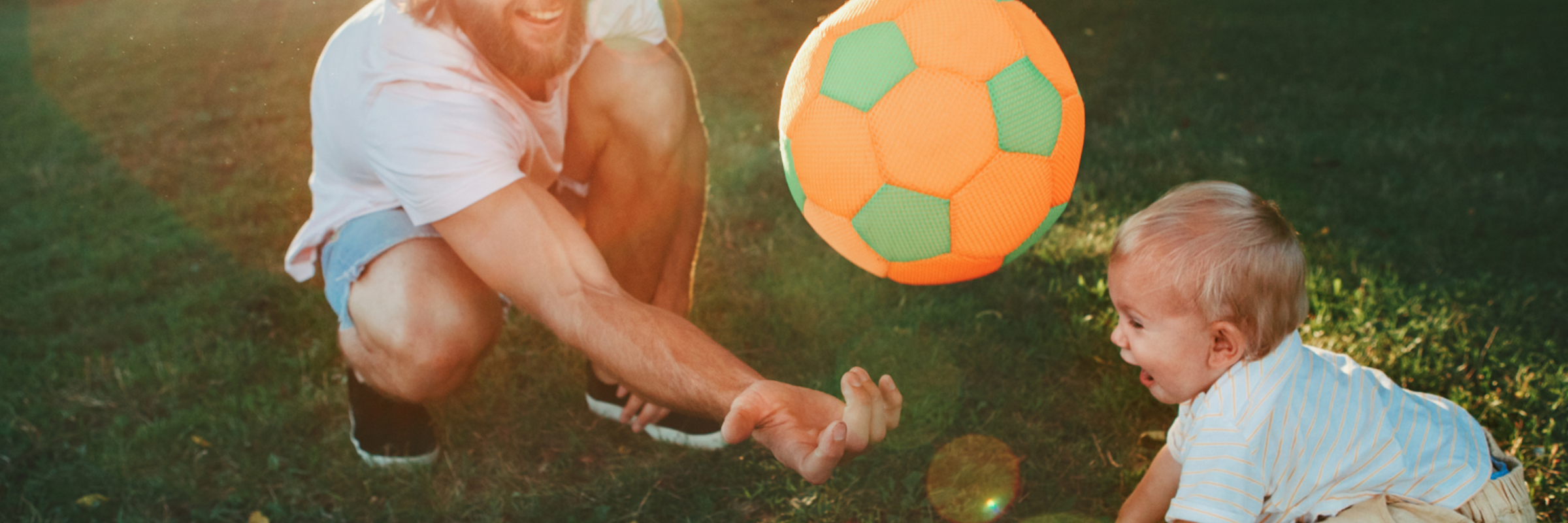 Man and child playing with balls