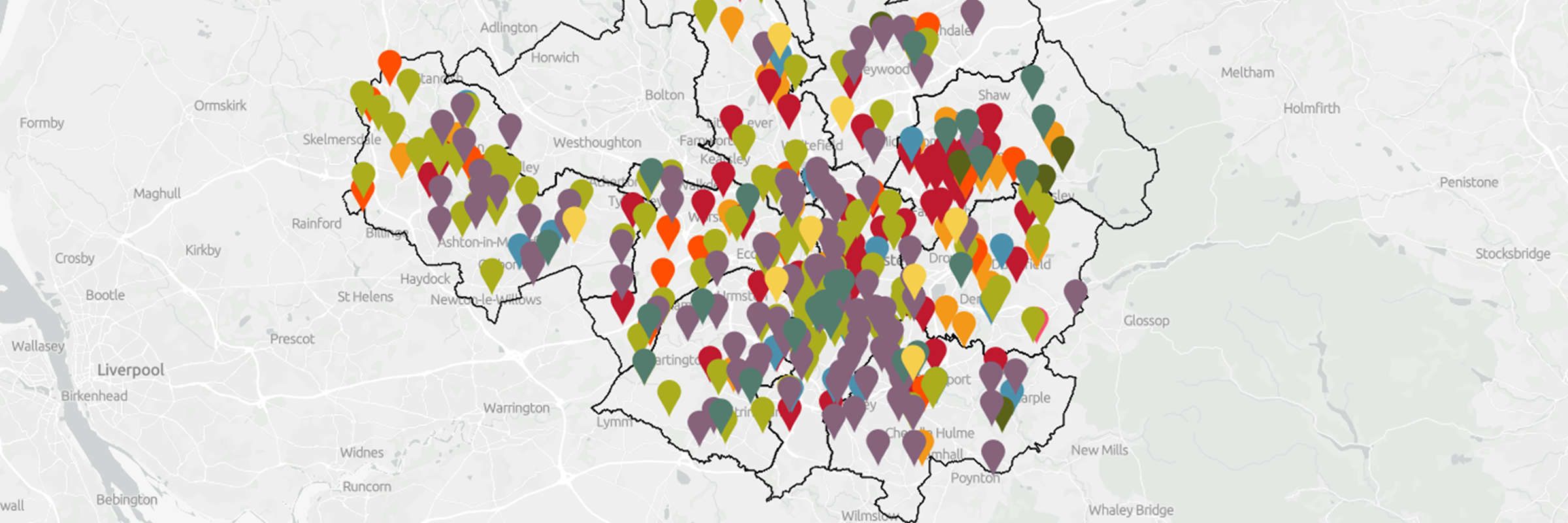 Outline map of Manchester with coloured pins representing different green recovery projects around the city region (decorative)