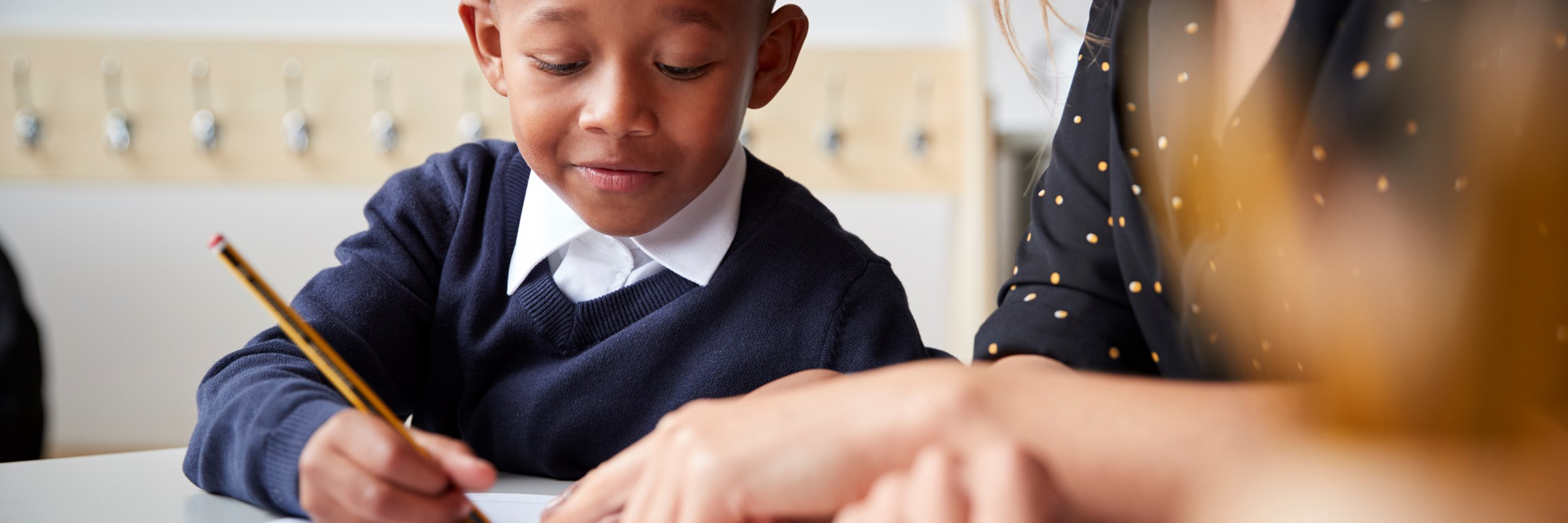 boy learning to write at school