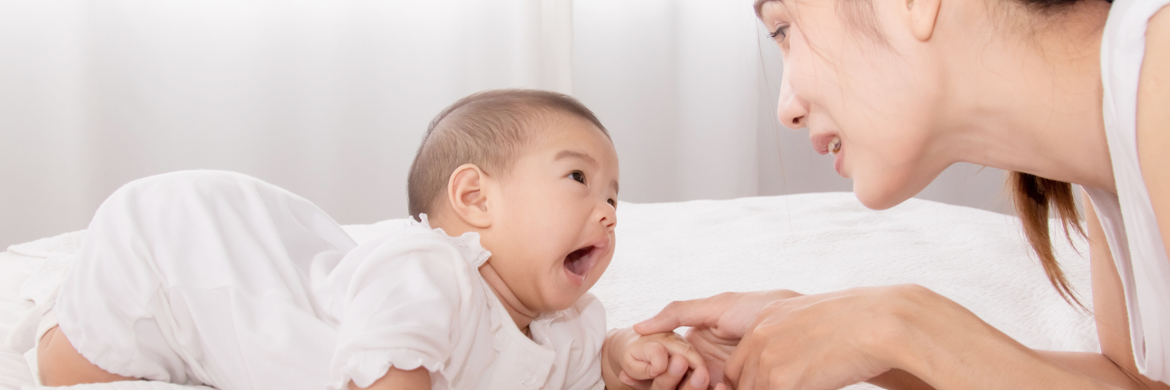 woman and baby playing