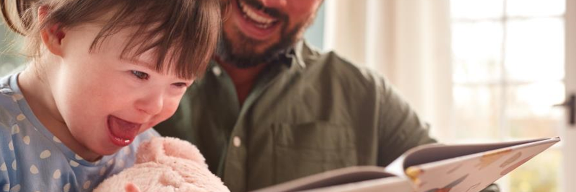 man and child reading book