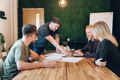 Image of team working round a table