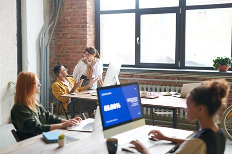 4 people working together in an office environment