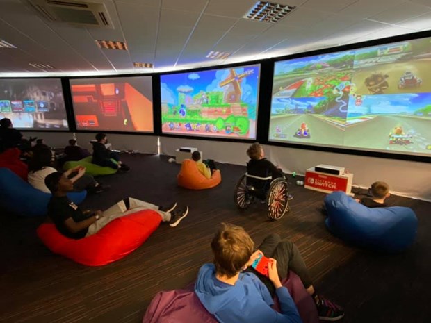 An image of a group of young people playing video games together