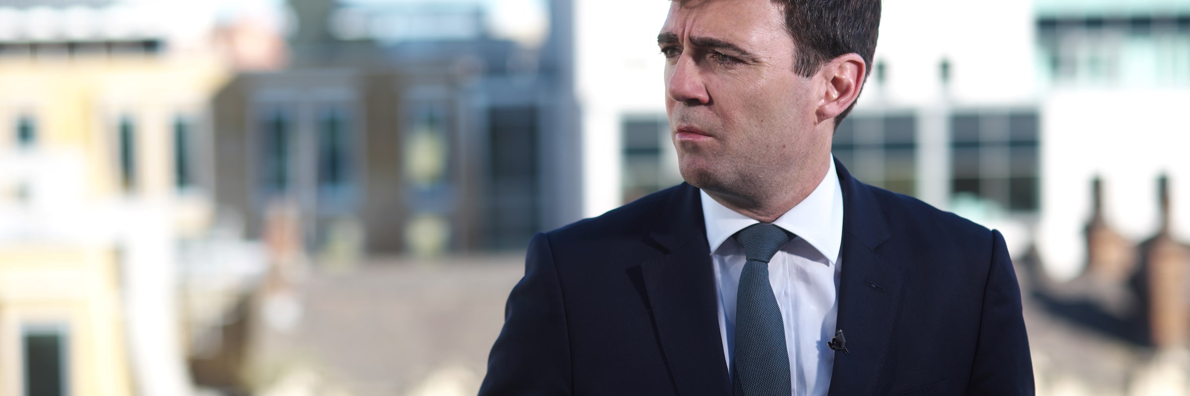 Mayor of Greater Manchester, Andy Burnham, in front of Manchester skyline