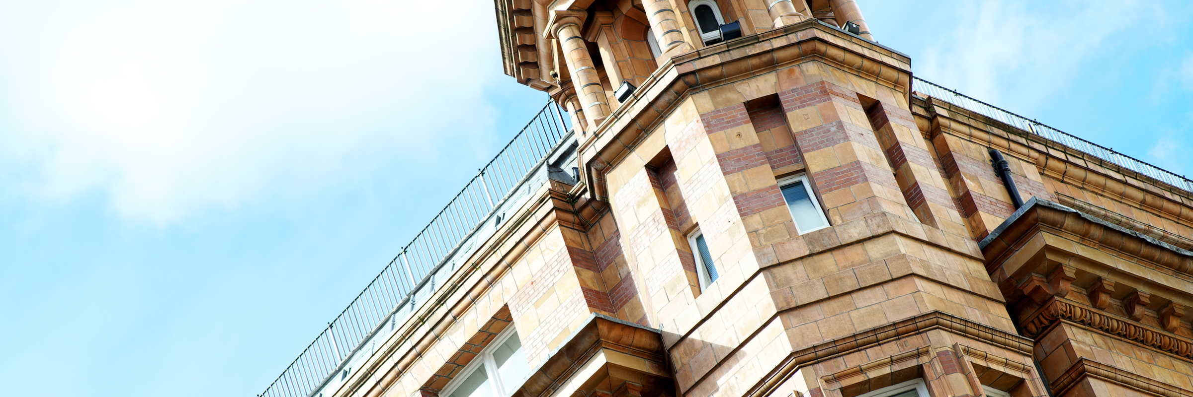 View looking up at Tootal Buildings - you can see a turret in front of blue sky