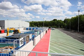 View of containers and parking spaces at a Household Waste Recycling Centre