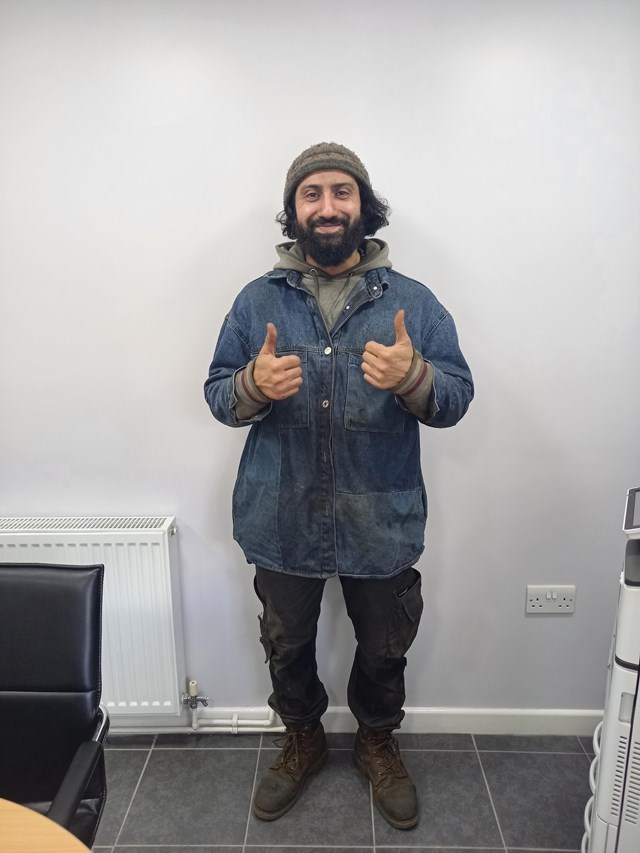 Ajmil Alfrid standing in room with thumbs up