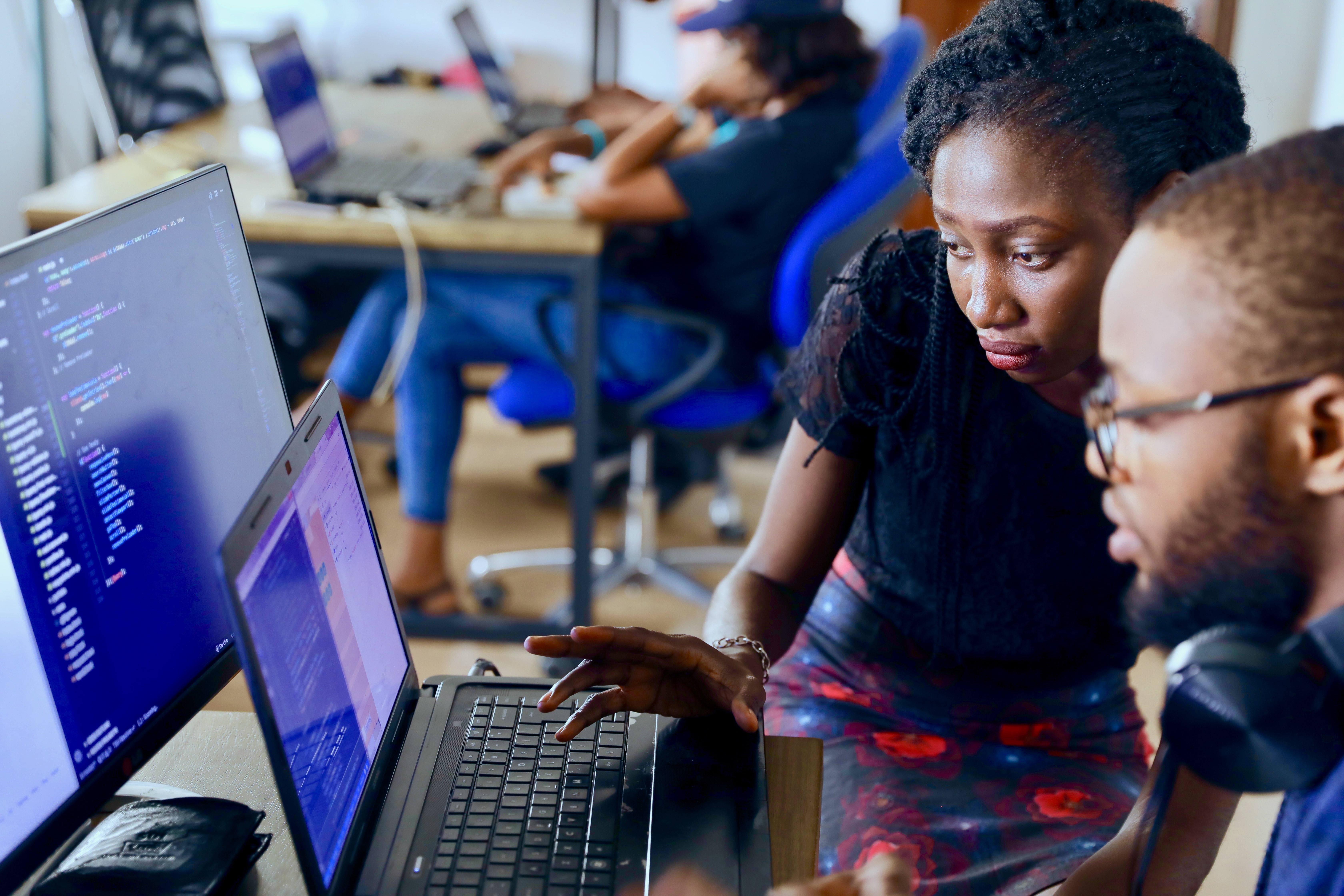 Image of people working together at a computer