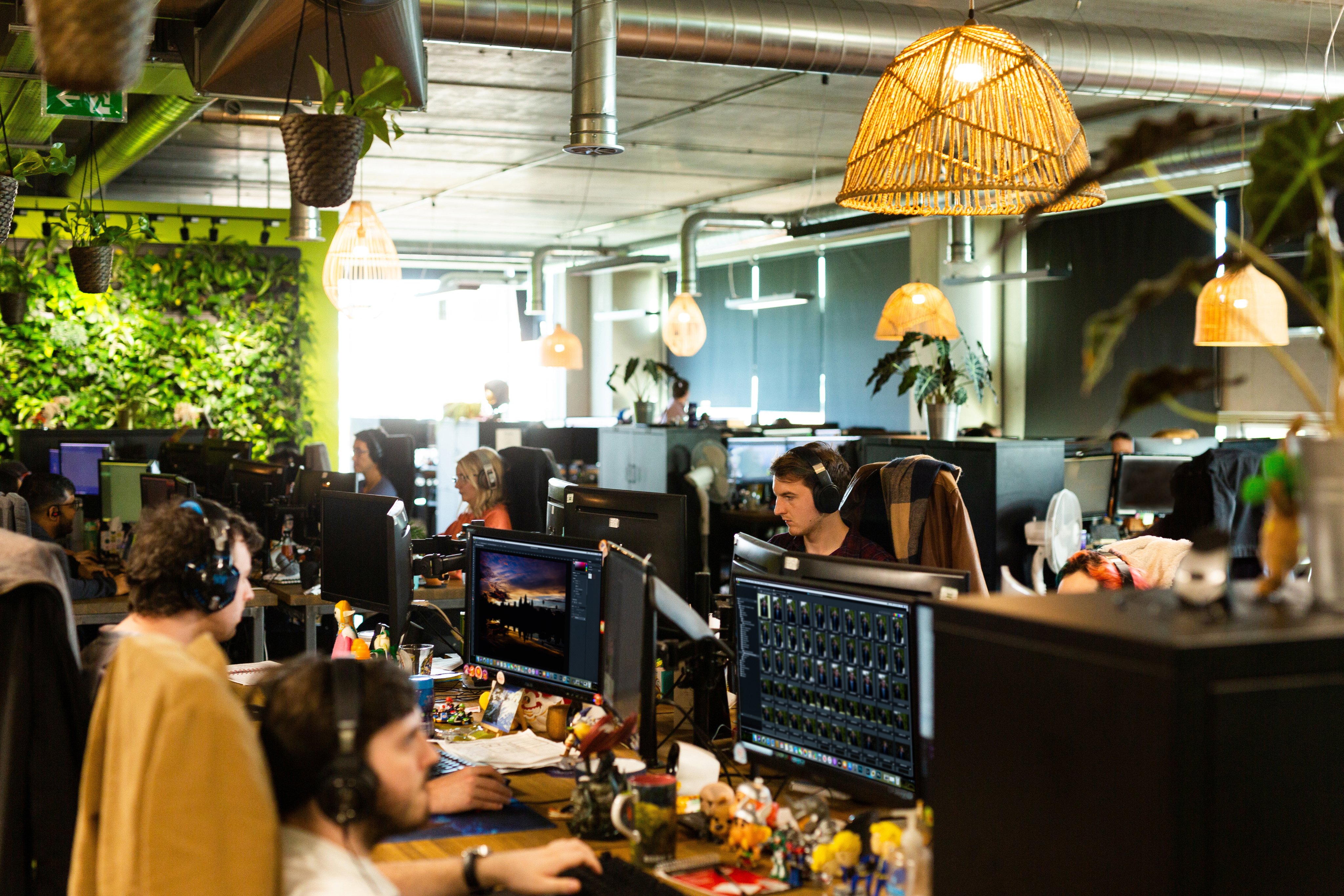 Image of an open office floor with people working at computers