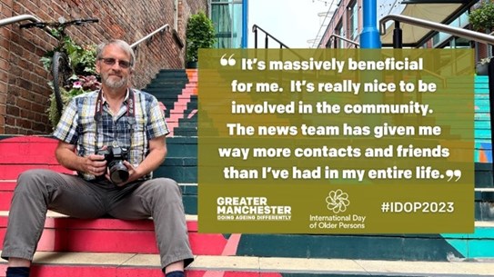 Man sitting on stairs holding a camera