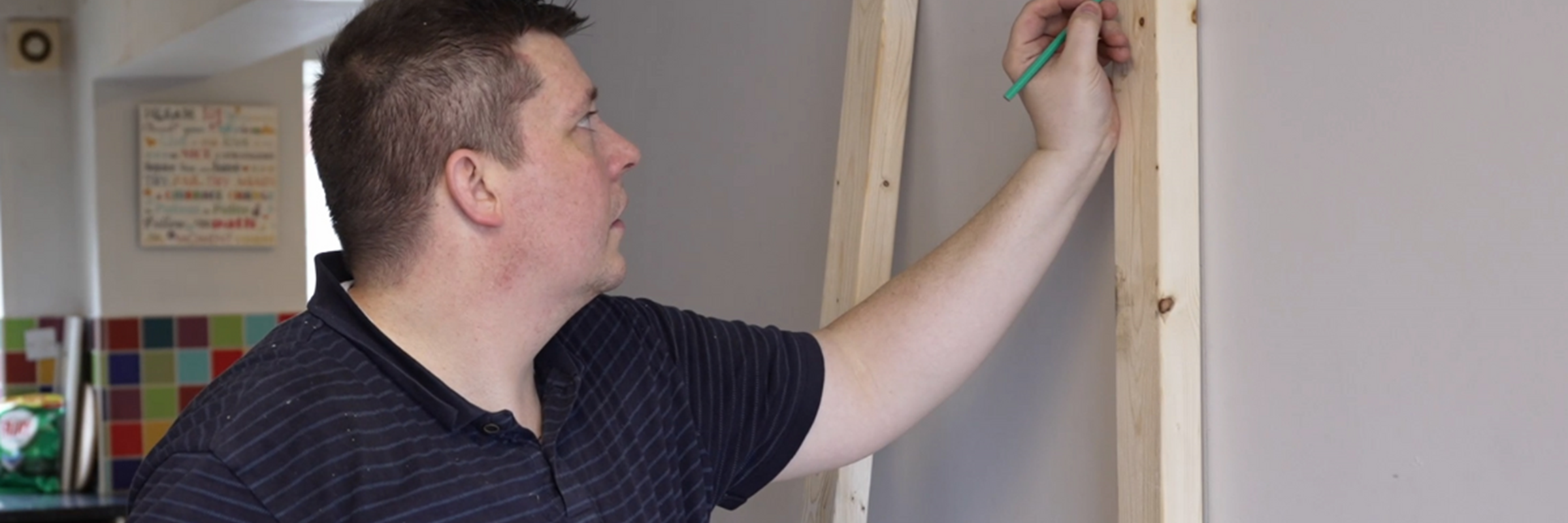 GM foster carer doing building and decorating work in a room
