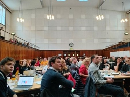 Room of people sat in a room look at presentation