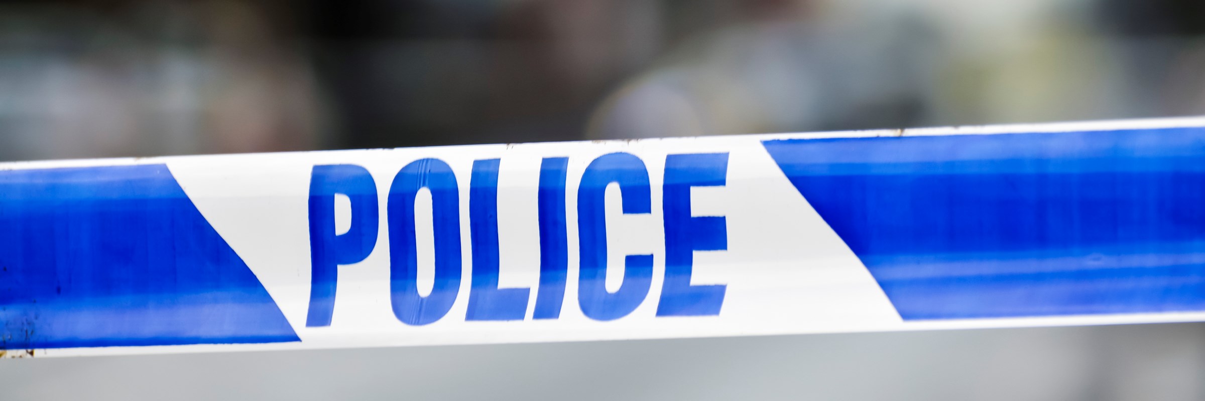 Police tape at the cordon of a crime scene.