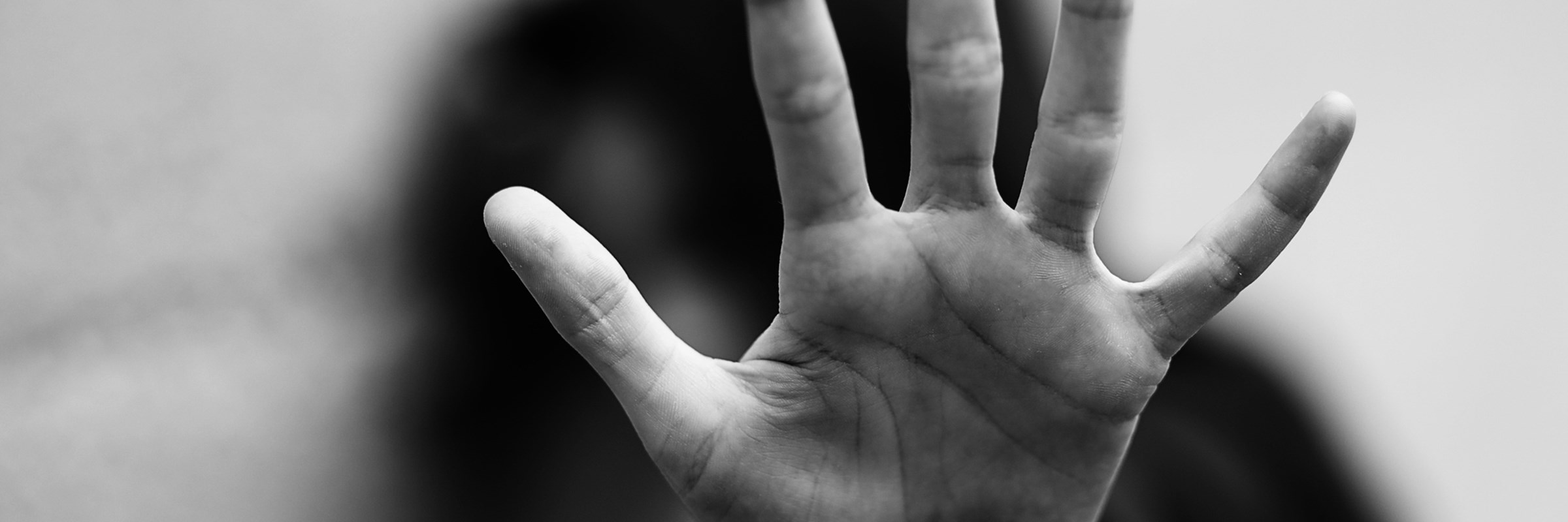 hand of a little girl who wants to protect herself from her attacker during abuse